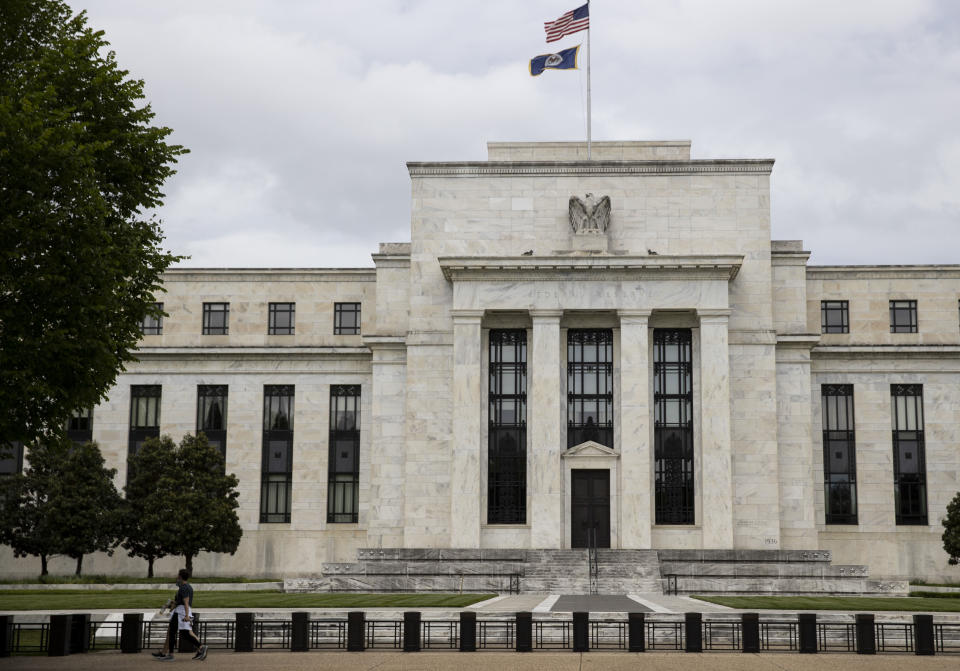 WASHINGTON, May 21, 2020  -- People walk past the U.S. Federal Reserve building in Washington D.C., the United States, May 21, 2020. U.S. Federal Reserve Chair Jerome Powell on Thursday said the COVID-19-induced economic downturn has inflicted acute pain across the country, noting that the burden is not evenly spread. (Photo by Ting Shen/Xinhua via Getty) (Xinhua/ via Getty Images)