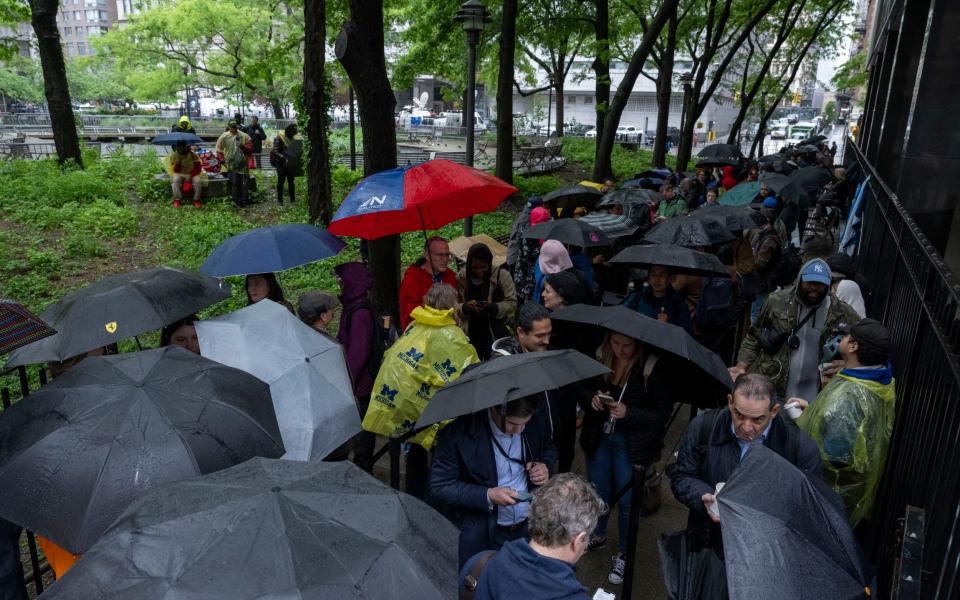 People queue outside Manhattan Criminal Court for the trial of former US President Donald Trump