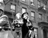 <p>Three-year-old Richard Caglione sheds tears as a stranger, in this case, Emmett Kelly, featured clown with Ringling Brothers and Barnum and Bailey Circus, picks him up during New York’s first circus parade in 19 years on April 9, 1945, which launched the first phase of the Seventh War Loan Drive. (AP Photo/Anthony Camerano) </p>