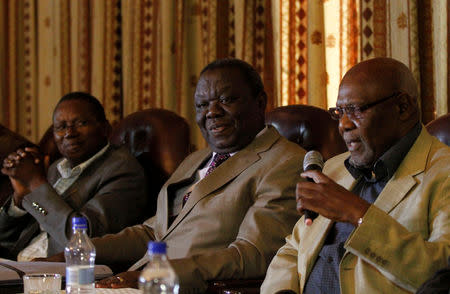 FILE PHOTO: Zimbabwe Movement For Democratic Change (MDC) leader Morgan Tsvangirai (C) and other opposition leaders Simba Makoni (L) of Mavambo Kusile (MDK) and ZAPU President Dumiso Dabengwa (R) address a media conference in Harare June 5, 2013.REUTERS/Philimon Bulawayo/File Photo