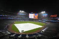 A tarp covers the infield after a scheduled baseball game between the Detroit Tigers and the New York Mets was postponed for inclement weather, Tuesday, April 2, 2024, in New York. (AP Photo/Frank Franklin II)