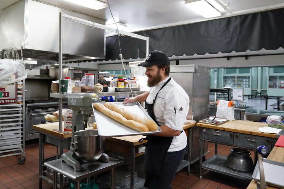 Chef Josh Gjersand moves two baguettes to the oven before preparing a salami sandwich for Mount Diablo High School students to try during a taste test in Concord, Calif., Friday, Jan. 13, 2023. (AP Photo/Godofredo A. Vásquez)