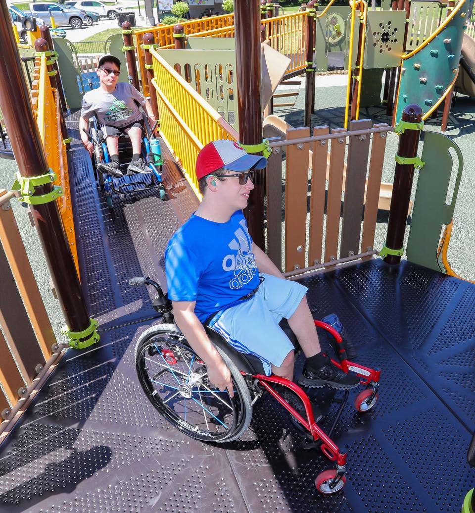 Mateo Shaw leads his brother McHale while visiting the Shaw Family Playground at Evergreen Park, Thursday, June 27, 2024, in Sheboygan, Wis.