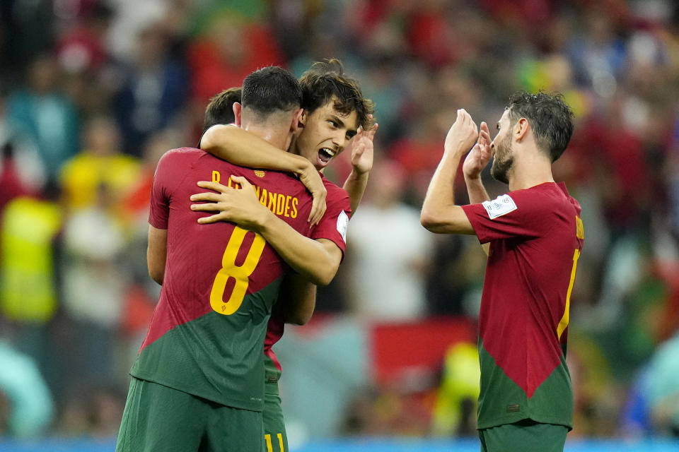 Portugal's Bruno Fernandes, Joao Felix and Bernardo Silva, from left celebrate at the end of the World Cup group H soccer match between Portugal and Uruguay, at the Lusail Stadium in Lusail, Qatar, Tuesday, Nov. 29, 2022. Portugal won 2-0. (AP Photo/Petr David Josek)