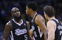 Sacramento Kings forward Rudy Gay (8) is surrounded by teammates forward Quincy Acy (5) and guard Jimmer Fredette (7) after being ejected from the game in the fourth quarter of an NBA basketball game against the Oklahoma City Thunder in Oklahoma City, Sunday, Jan. 19, 2014. Oklahoma City won 108-93. (AP Photo/Sue Ogrocki)