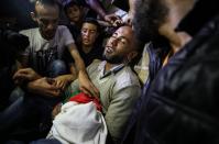 <p>Palestinians mourn over the body of eight-month-old Palestinian baby Leila Anwar Ghandoour, died from tear gas inhalation during clashes in Gaza the previous day, during her funeral in Gaza City on May 15, 2018. (Photo: Mustafa Hassona/Anadolu Agency/Getty Images) </p>