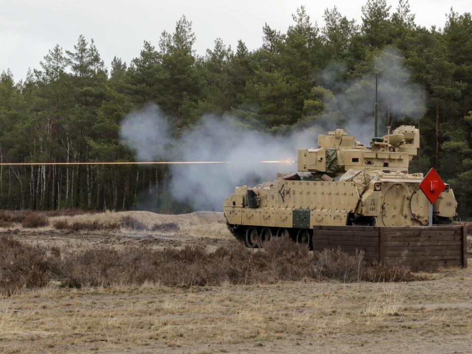 A US Army M2 Bradley Infantry Fighting Vehicle assigned to the 1st Squadron, 4th Cavalry Regiment, 1st Armored Brigade Combat Team, 1st Infantry Division fires its weapon at Trzebien, Poland, Feb. 22, 2022.