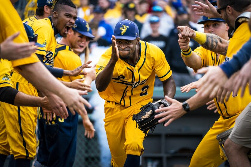 Savannah Banana Malachi Mitchell (2) and other members of the starting lineup take to the field