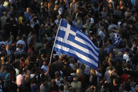 Protesters wave a Greek flag during an anti-austerity rally in Athens, Greece, June 29, 2015. REUTERS/Alkis Konstantinidis