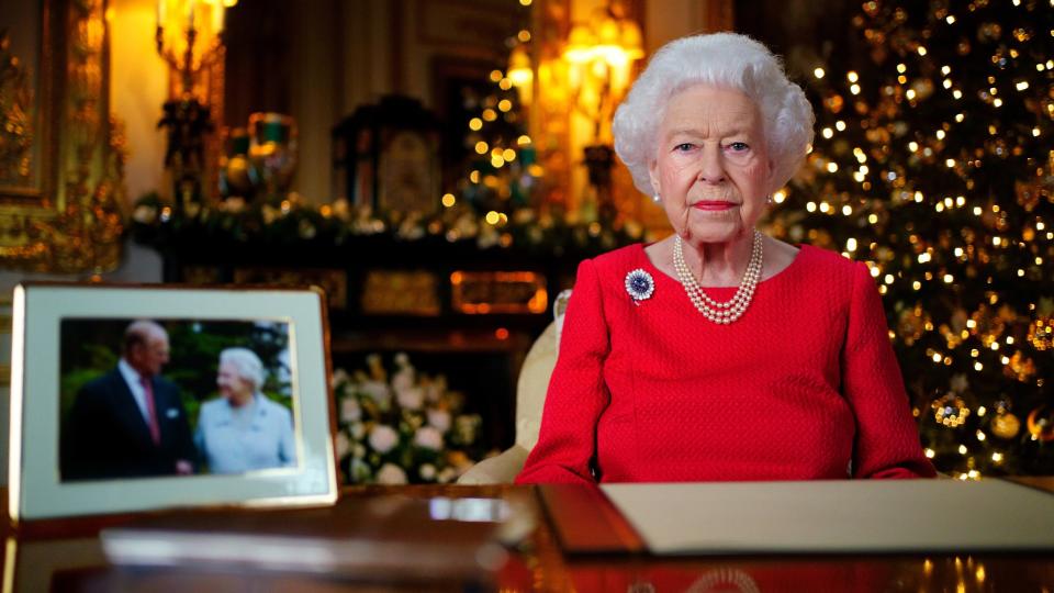 Queen Elizabeth II records her annual Christmas broadcast in the White Drawing Room at Windsor Castle on December 23, 2021 in Windsor, England. The photograph on the desk is of The Queen and the Duke of Edinburgh, taken in 2007 at Broadlands, Hampshire, to mark their Diamond Wedding Anniversary.