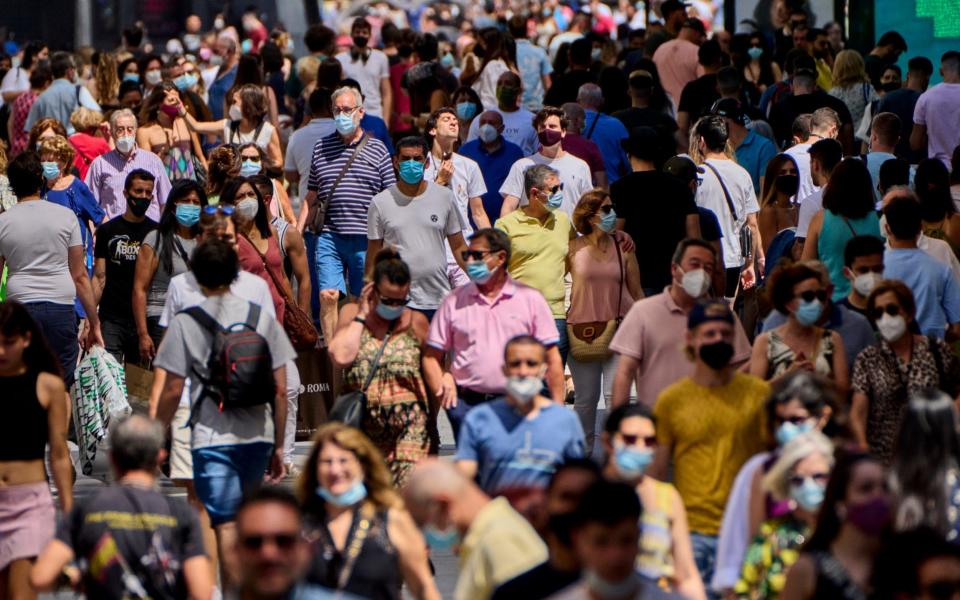 It's a mixed picture in Madrid, Spain, as some choose to keep wearing masks outdoors despite the year-long requirement to do so finally being dropped - Manu Fernandez/AP