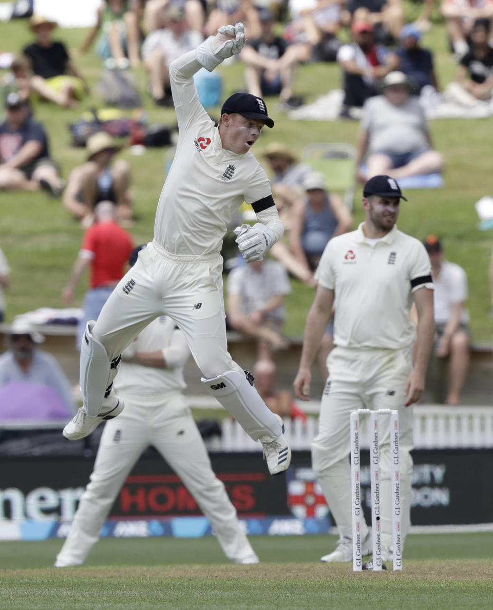 England's Ollie Pope reacts after he attempted to catch a ball during play on day one of the second cricket test between England and New Zealand at Seddon Park in Hamilton, New Zealand, Friday, Nov. 29, 2019. (AP Photo/Mark Baker)