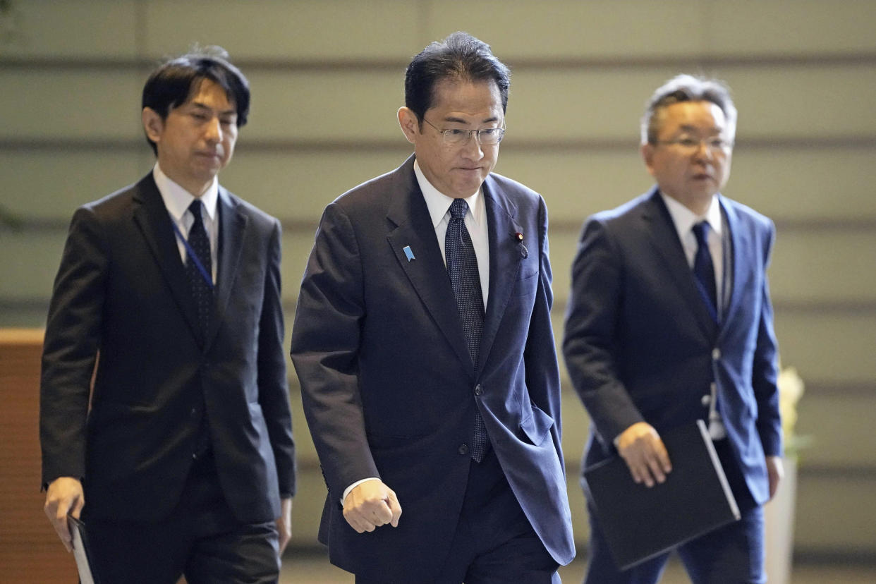 Japan's Prime Minister Fumio Kishida, center, arrives at his office in Tokyo following a report of a launching from North Korea Wednesday, May 31, 2023. North Korea launched a rocket Wednesday, South Korea and Japan said, prompting brief evacuations in those countries as the North appeared to be attempting to put its first military spy satellite into orbit. (Kyodo News via AP)