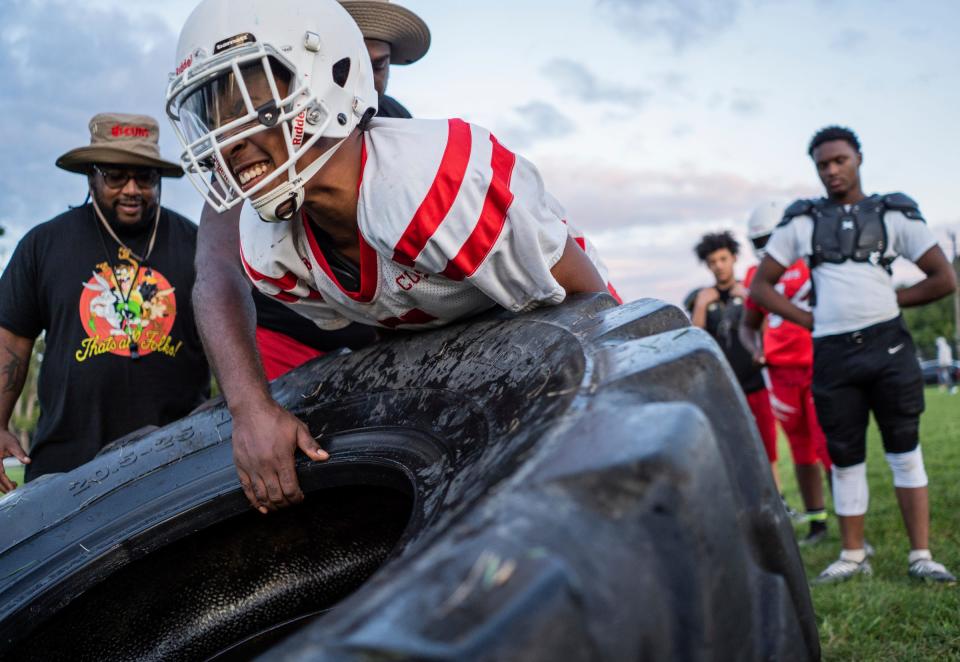 Maurice Fielding of Detroit struggles while flipping a large tire during a practice for the West Side Cubs 14U football team at McCabe Field in Detroit on Tuesday, September 12, 2023. More than just youth football and cheerleading teams, the West Side Cubs represent a vital community institution with a 66-year history.