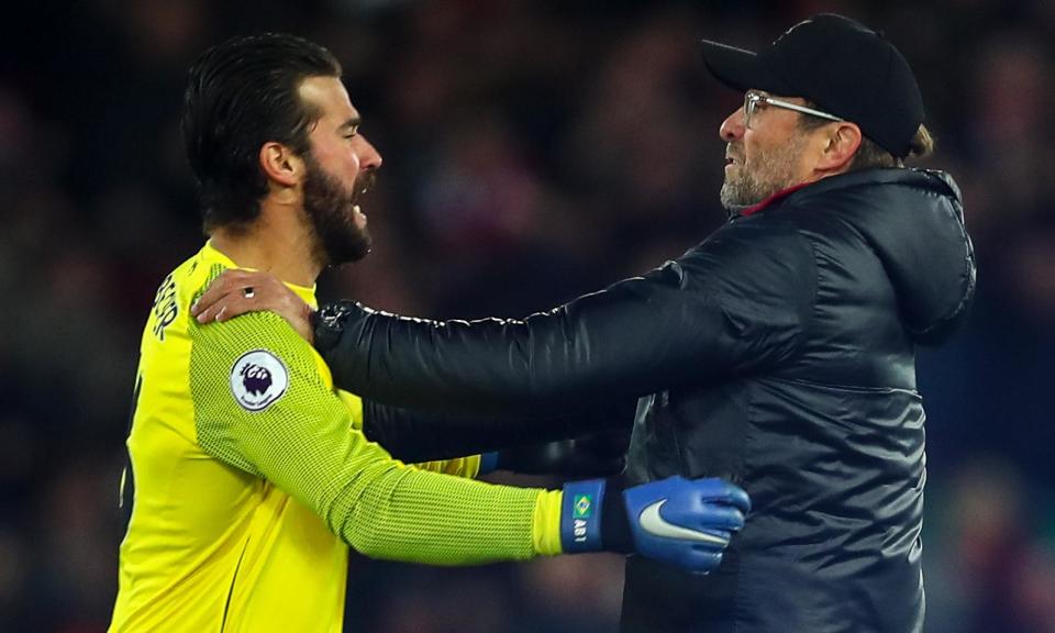 Jurgen Klopp celebrates with Alisson on the pitch after Divock Origi’s late goal.