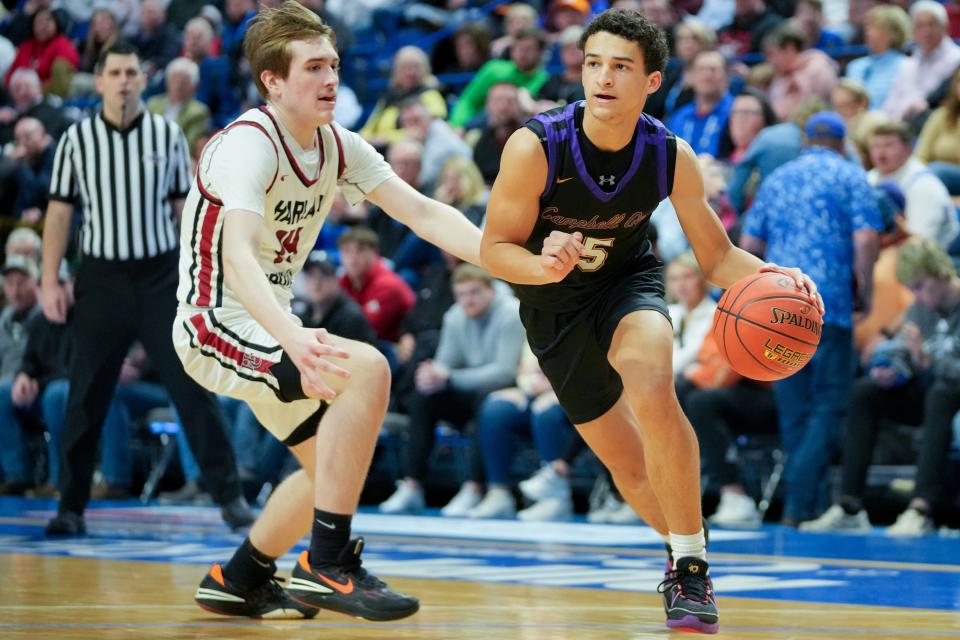 Campbell County Camels guard Garyn Jackson (15) drives to the basket as Harlan County Black Bears guard Brody Napier (14) defends in the second half of a quarterfinal game during the 2024 KHSAA boys state basketball tournament, Friday, March 22, 2024, at Rupp Arena in Lexington, Ky.