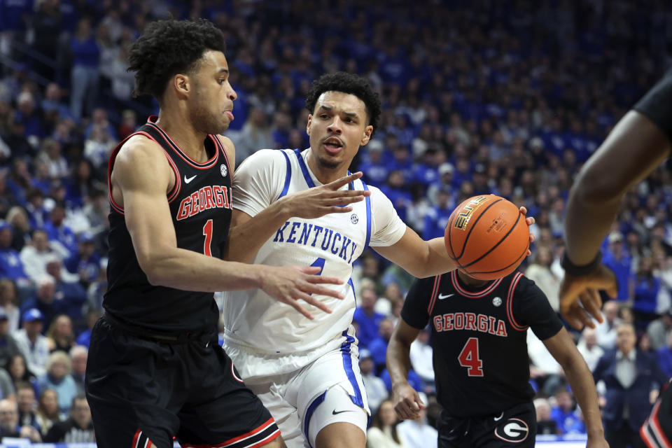 Kentucky's Tre Mitchell drives against Georgia's Jabri Abdur-Rahim, left, during the first half of an NCAA college basketball game Saturday, Jan. 20, 2024, in Lexington, Ky. (AP Photo/James Crisp)