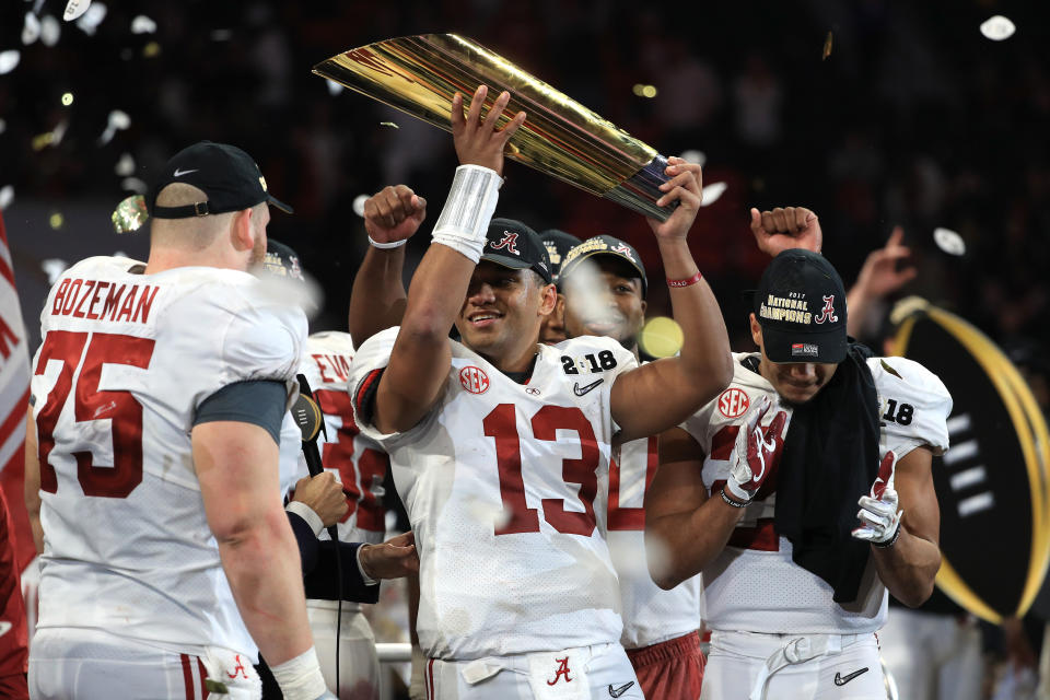 Alabama quarterback Tua Tagovailoa holds up the CFP National Championship trophy at Mercedes-Benz Stadium on January 8, 2018 in Atlanta, Georgia. (Getty)