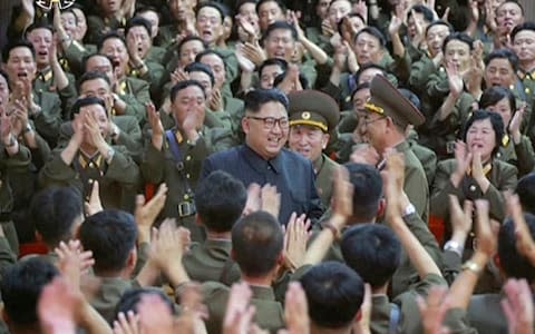 North Korean leader Kim Jong Un is seen being applauded at a performance in Pyongyang, in footage released on Tuesday - Credit: AP