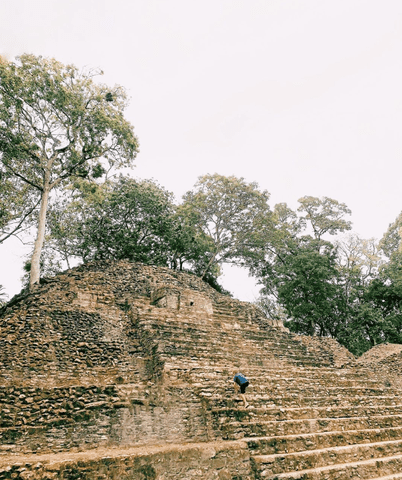 The author's son climbing the ancient Mayan ruins of Cahal Pech in Belize.