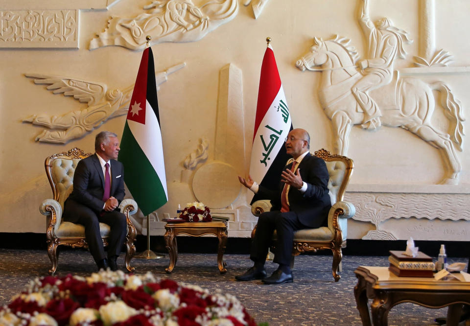 Iraqi President Barham Salih, right, meets with visiting Jordanian King Abdullah II after his arrival to Baghdad, Iraq, Sunday, June 27, 2021. (AP Photo/Khalid Mohammed)