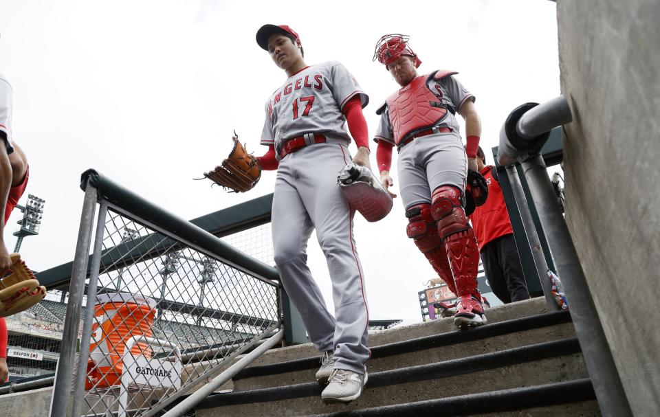 Pitcher Shohei Ohtani of the Los Angeles Angels enters the dugout with catcher Chad Wallach before game one of a doubleheader against the Detroit Tigers at Comerica Park on July 27, 2023 in Detroit, Michigan.