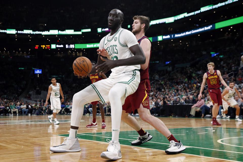 Boston Celtics' Tacko Fall, left, looks to move against Cleveland Cavaliers' Dean Wade during the second half of an NBA preseason basketball game in Boston, Sunday, Oct. 13, 2019. (AP Photo/Michael Dwyer)