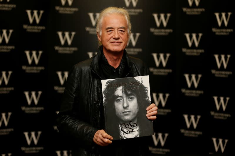 FILE PHOTO: Guitarist Jimmy Page of rock band Led Zeppelin poses for photographers during a book signing for his book "Jimmy Page" at Waterstones in London