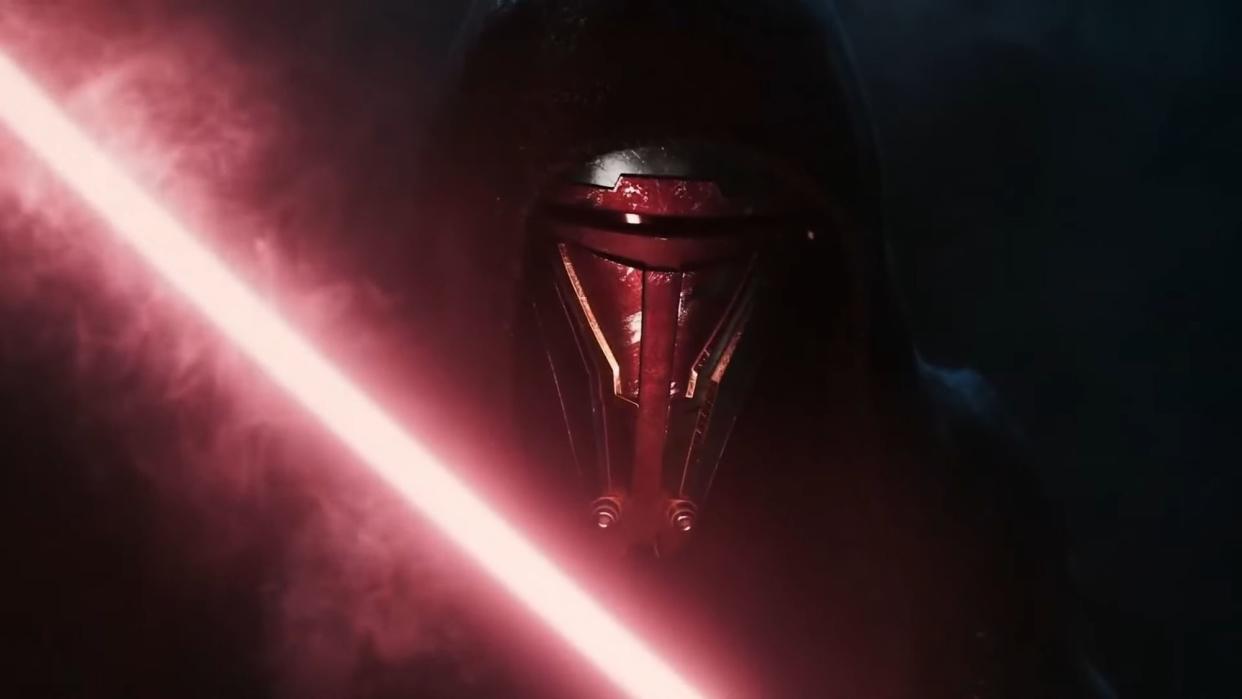  A close up of Darth Revan behind a red lightsaber. 