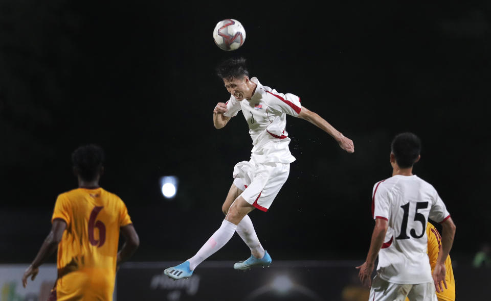 North Korea's Kuk Chol, center, heads the ball during the World Cup Group H Asia qualifying soccer match between Sri Lanka and North Korea in Colombo, Sri Lanka, Tuesday, Sept. 10, 2019. North Korea defeated Sri Lanka by 1-0. (AP Photo/Eranga Jayawardena)