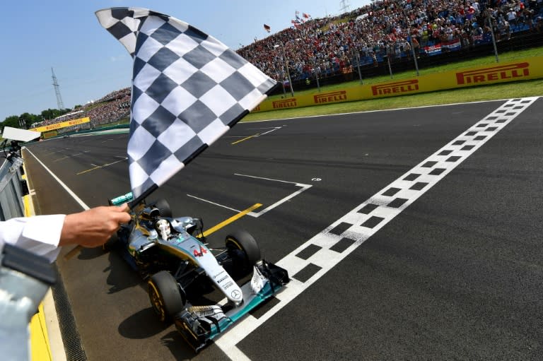 Lewis Hamilton crosses the finish line to win the Hungarian Grand Prix at the Hungaroring circuit in Mogyorod on July 24, 2016