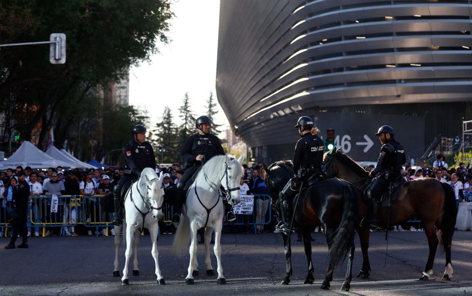 Spanish National Police officers conduct security cordon outside the Santiago Bernabeu