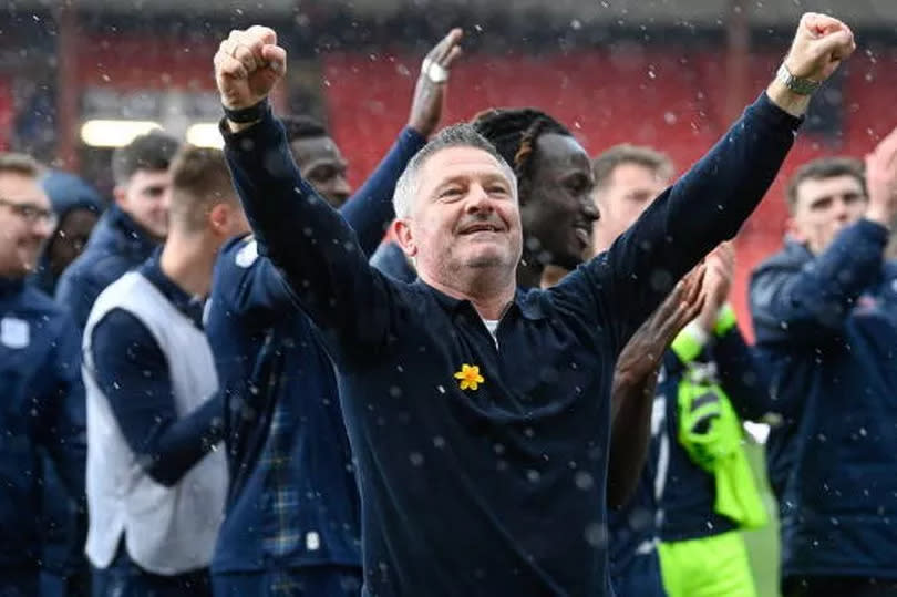 Former Dons No.2 Tony Docherty celebrates sealing a top six finish with the Dundee fans