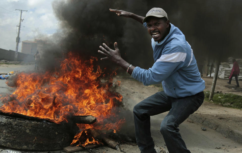 <p>An opposition supporter gestures at a barricade during clashes with police in the Jacaranda grounds quarter in Nairobi, Kenya, Tuesday, Nov. 28, 2017. (Photo: Brian Inganga/AP) </p>