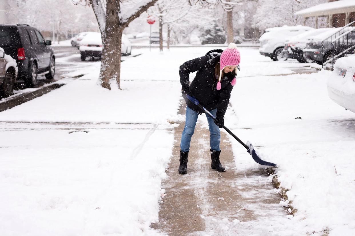 Woman shoveling snow