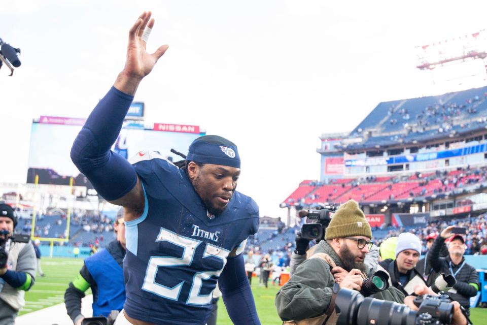 Tennessee Titans running back Derrick Henry (22) waves to the fans as he leaves the field against the Jacksonville Jaguars during the second half at Nissan Stadium.