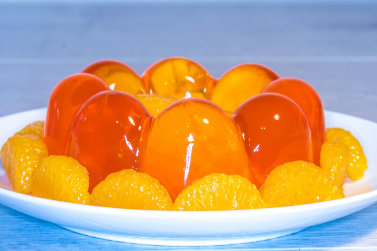 Close Up of translucent mouthwatering Orange Jelly/Jello Mould with orange segments, using a macro lens.