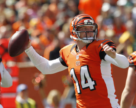 Cincinnati Bengals quarterback Andy Dalton (14) throws under pressure from the Green Bay Packers defense during the first half of play in their NFL football game at Paul Brown Stadium in Cincinnati, Ohio, September 22, 2013. REUTERS/John Sommers II