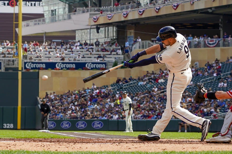 Minnesota Twins' Trevor Larnach hits a single driving in a run against the Los Angeles Angels during the second inning of a baseball game Sunday, Sept. 24, 2023, in Minneapolis. Alex Kirilloff scored. (AP Photo/Craig Lassig)