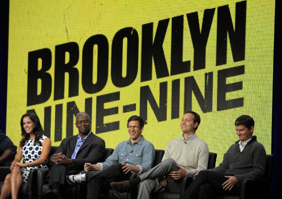 FILE - In this Aug. 1, 2013 file photo, from left, "Brooklyn Nine-Nine" cast members Melissa Fumero, Andre Braugher and Andy Samberg, and co-creators/executive producers Dan Goor and Michael Schur take part in a panel discussion on the series during the FOX 2013 Summer TCA press tour at the Beverly Hilton Hotel, in Beverly Hills, Calif. Fox says the plum post-Super Bowl slot next February will be filled by two of its comedies. "New Girl" and freshman series "Brooklyn Nine-Nine" will air on Fox after the game that’s typically TV’s most-watched program and a big promotional platform for other network fare. (Photo by Chris Pizzello/Invision/AP, File)