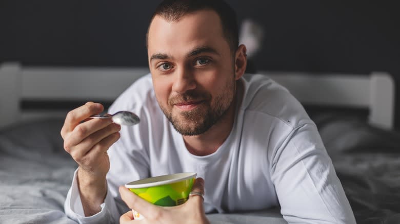 person eating ice cream pint