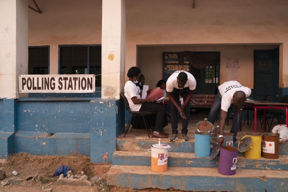 Electoral workers prepare the ballot drums at a polling station in Bakau, Gambia, Saturday, Dec. 4, 2021. Gambians vote in a historic election that will for the first time not have former dictator Yahya Jammeh, who ruled for 22 years, on the ballot. (AP Photo/Leo Correa)