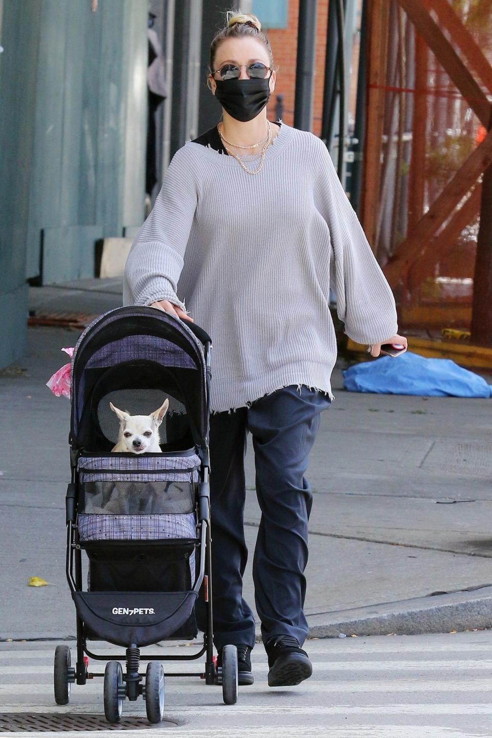 <p>Kaley Cuoco heads out in N.Y.C. on Saturday with her dog Dumpy in a stroller, as they make their way to Hudson River Park.</p>