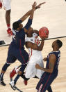 Iowa State's Dustin Hogue goes up between Connecticut's DeAndre Daniels, left, and Phillip Nolan during the first half in a regional semifinal of the NCAA men's college basketball tournament Friday, March 28, 2014, in New York. (AP Photo/Julio Cortez)