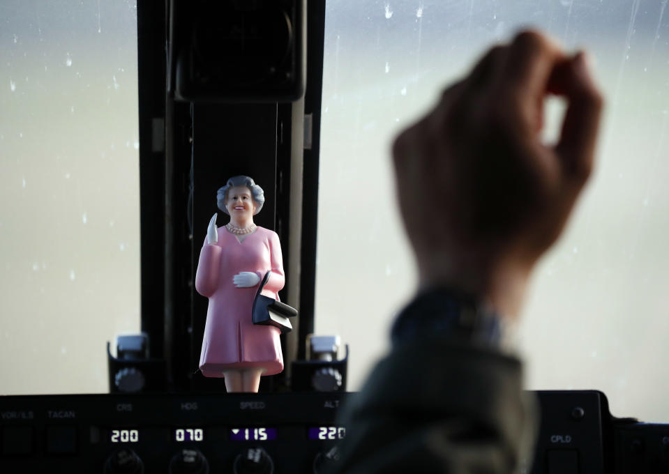 A doll of Queen Elizabeth II sits on the console of Osprey helicopter transporting members of the media traveling to the arrival of President Donald Trump and first lady Melania Trump at Blenheim Palace near Woodstock, Oxfordshire, England, July 12, 2018. (AP Photo/Pablo Martinez Monsivais)