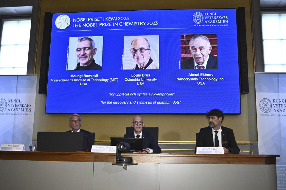 Permanent Secretary of the Royal Academy of Sciences Hans Ellegren, center, announces the winner of the 2023 Nobel Prize in Chemistry, at the Royal Academy of Sciences, in Stockholm, Wednesday, Oct. 4, 2023. The Nobel Prize in physics has been awarded to scientists Moungi Bawendi, Louis Brus and Alexi Ekimov for discovery and synthesis of quantum dots. (Claudio Bresciani/TT News Agency via AP)