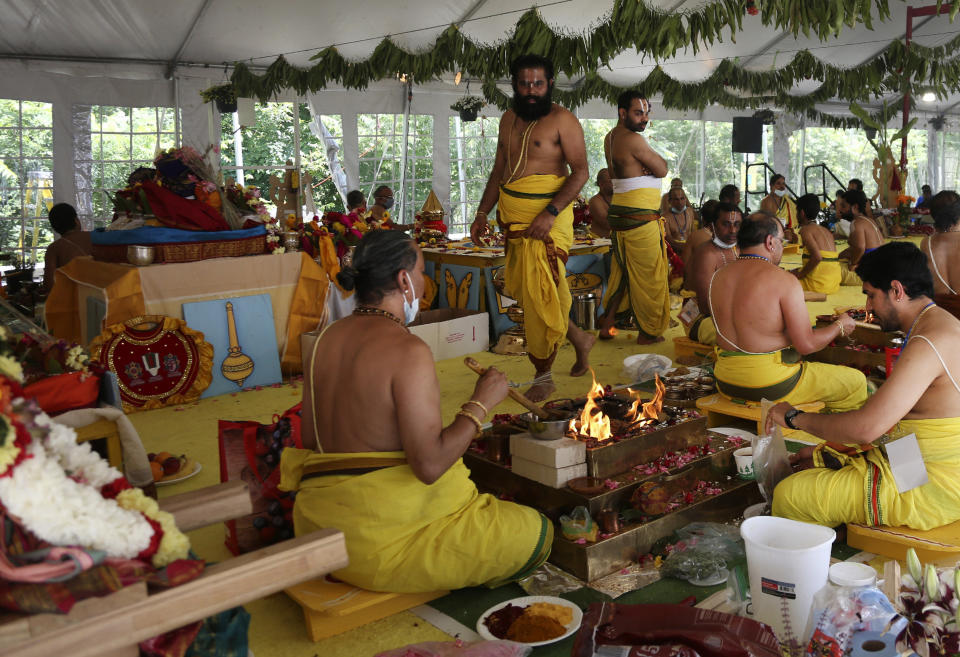 Priests make offerings to the deities through individual fires during the Maha Kumbhabhishekam, a five-day Hindu rededication ceremony, at the Sri Venkateswara Temple in Penn Hills, Pa., Friday, June 25, 2021. (AP Photo/Jessie Wardarski)