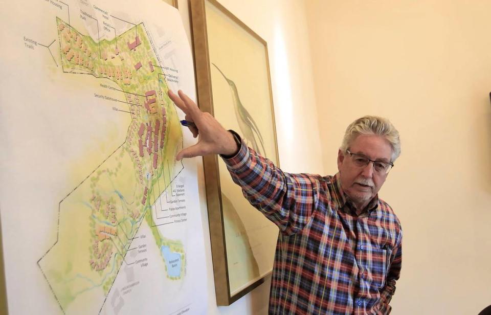 The Villaggio project has been canceled due to delays and “numerous obstacles,” CEO Mark De Lotto told The Tribune. Here Village representative Vic Montgomery points to a project map while discussing the project in 2019.