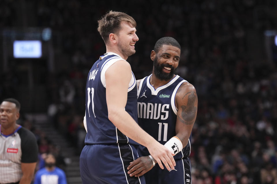 Dallas Mavericks' Luka Doncic and Kyrie Irving react during their team's win over the Toronto Raptors after an NBA basketball game in Toronto on Wednesday, Feb. 28, 2024. (Chris Young/The Canadian Press via AP)
