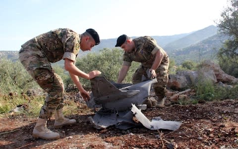 Lebanese soldiers inspect remains of a surface to air missile that landed in the southern Lebanon after being fired by Iranian forces from Syria on the Israeli-occupied Golan - Credit: AFP